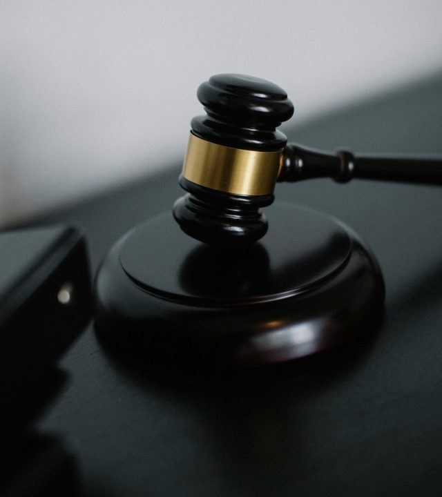 pexels-photo-5668473-5668473 Close-up of a wooden gavel on a desk, symbolizing justice and legal authority.